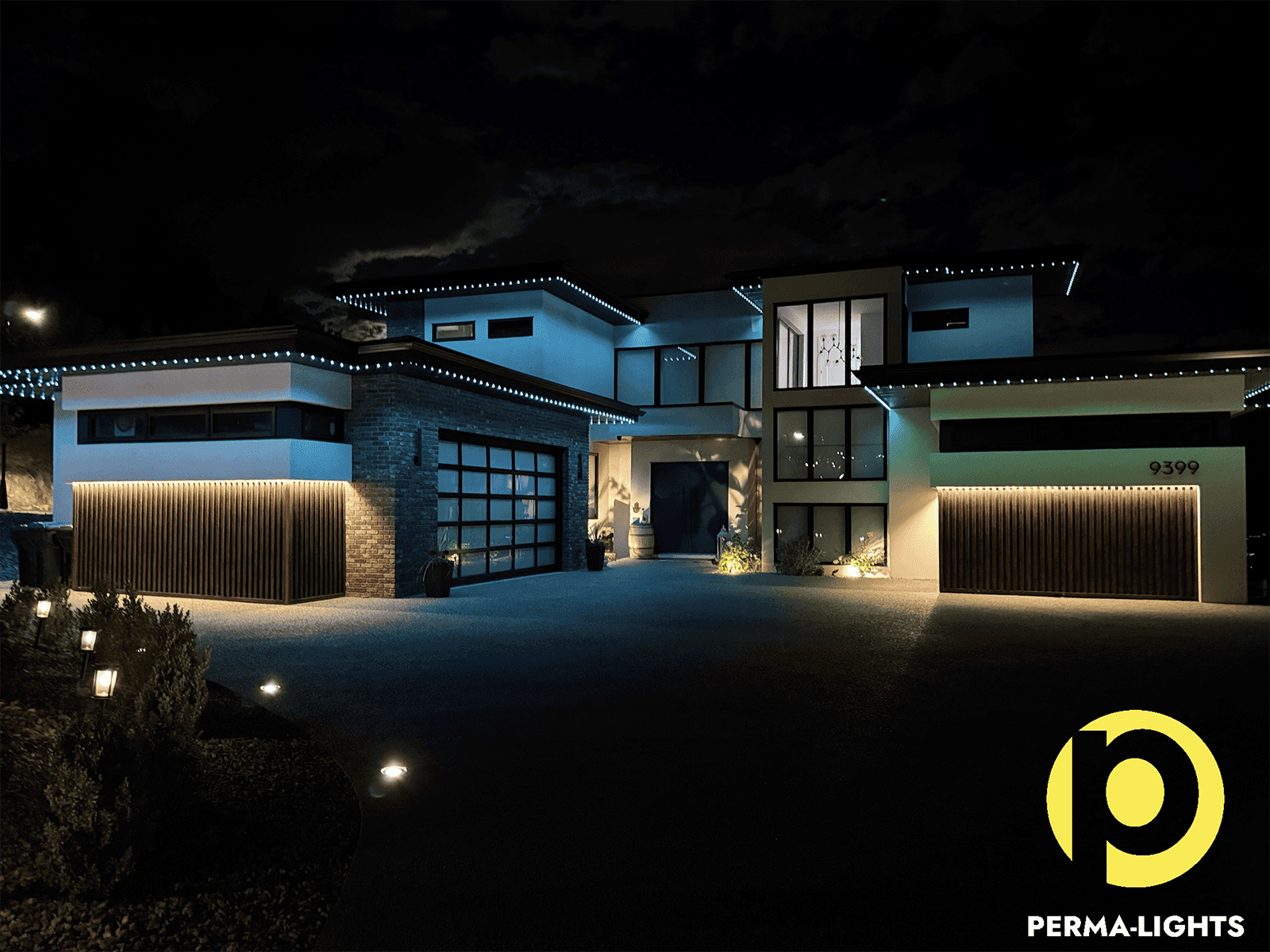 Lake Country modern home with cool white and soft accent lighting from a permanent outdoor LED system.